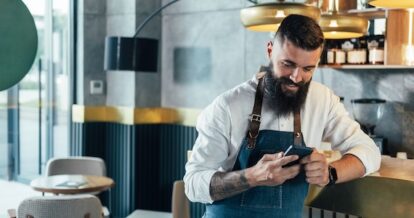 Restaurant staff looking at their mobile device.