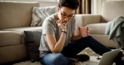 Restaurant owner brainstorming with coffee and laptop