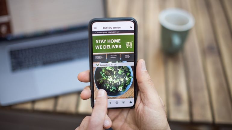 A person using a mobile phone to place an online food order