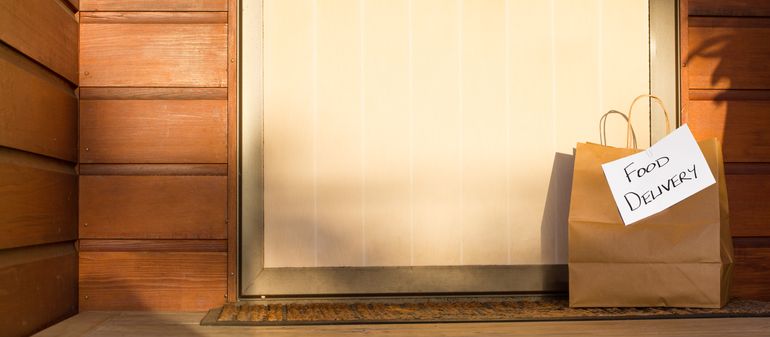 Food delivery in paper bag left on door step