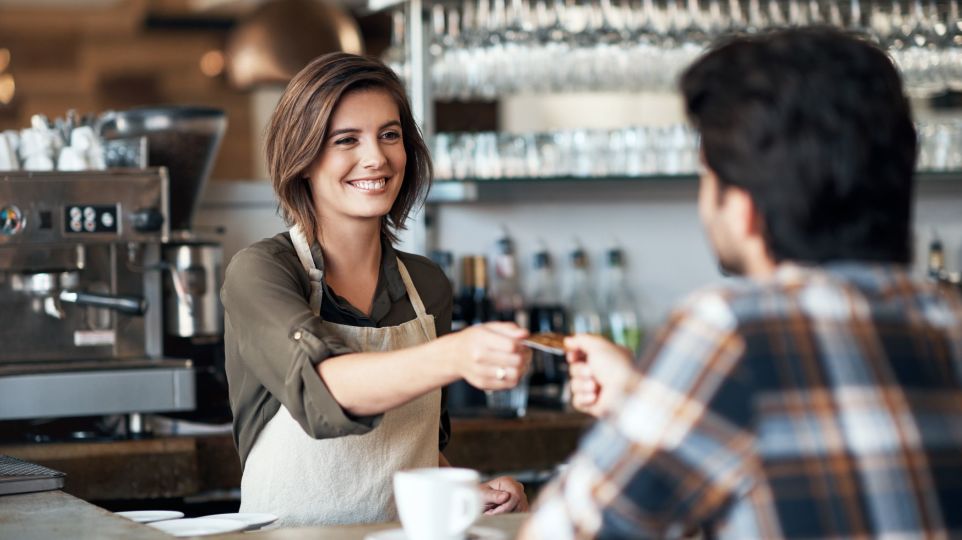 counter staff taking payment from customer