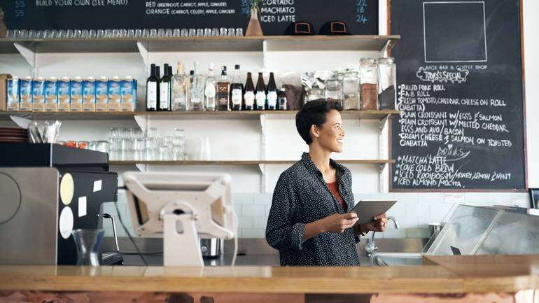cafe owner with POS behind counter