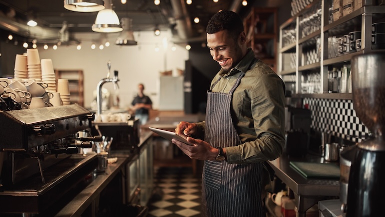 Restaurant staff member using a tablet.
